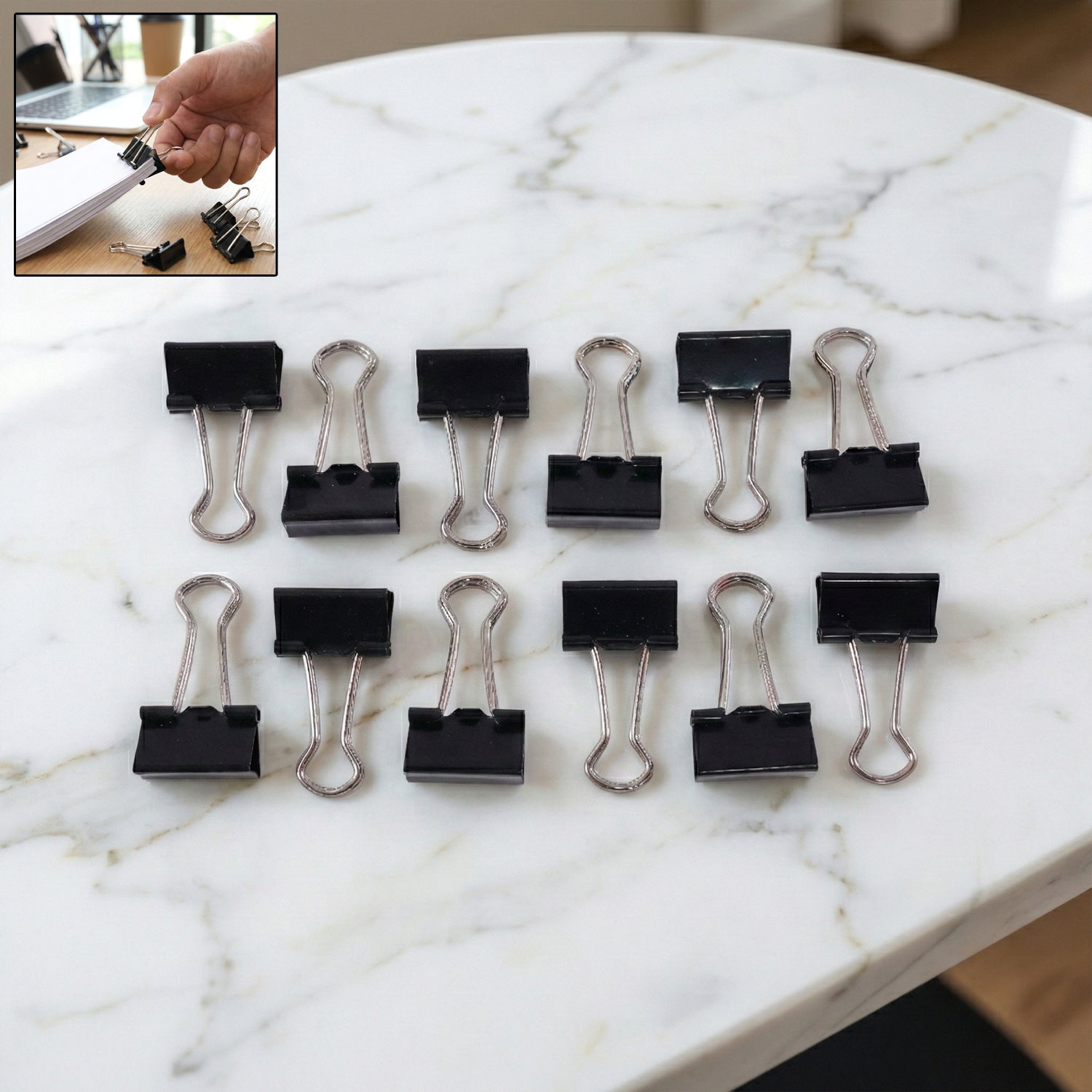 Black metal binder clips piled