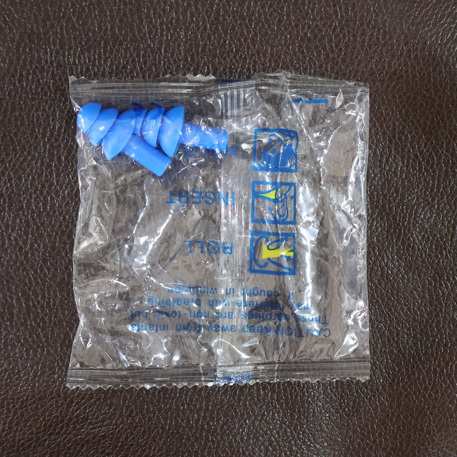 Swimmer wearing soft silicone ear plugs in water
