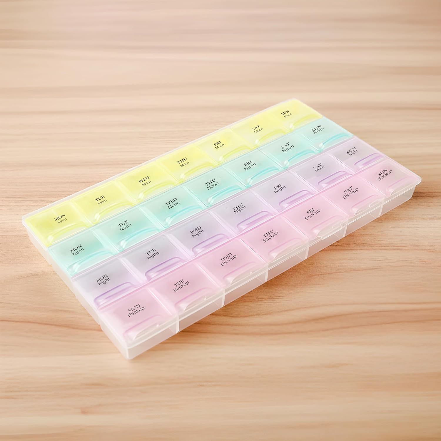Portable pill organizer with easy-open lids and clear compartments.